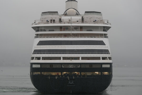 Classic luxury cruiseship cruise ship liner Zaandam Volendam arrival to Vancouver, BC after Alaska wilderness adventure Last frontier landscape nature scenery cruising with low hanging clouds misty