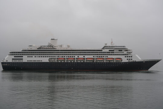 Classic luxury cruiseship cruise ship liner Zaandam Volendam arrival to Vancouver, BC after Alaska wilderness adventure Last frontier landscape nature scenery cruising with low hanging clouds misty