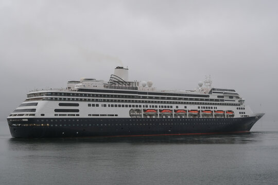 Classic luxury cruiseship cruise ship liner Zaandam Volendam arrival to Vancouver, BC after Alaska wilderness adventure Last frontier landscape nature scenery cruising with low hanging clouds misty