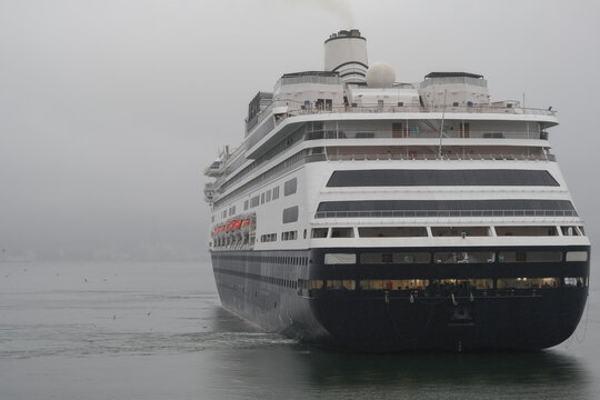 Classic luxury cruiseship cruise ship liner Zaandam Volendam arrival to Vancouver, BC after Alaska wilderness adventure Last frontier landscape nature scenery cruising with low hanging clouds misty