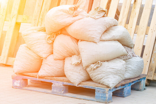 Construction debris in bags sits on a wooden pallet