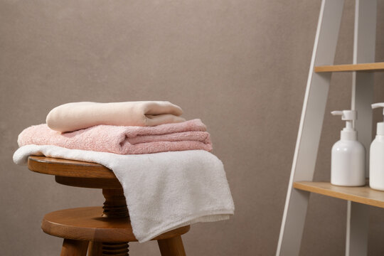 Soft Towels Stacked on Stool