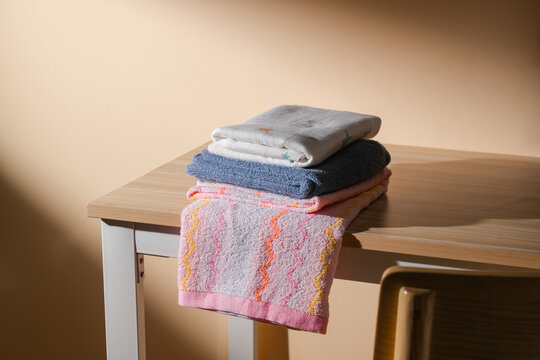 Stack of Folded Towels  on a wooden table