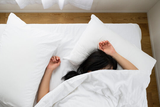 Sleeping in white bedding