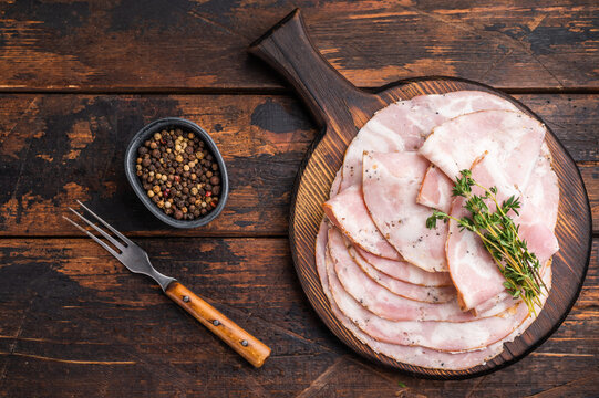 Overhead shot of a gourmet charcuterie platter on a vintage wooden background with excellent copy space on the right.