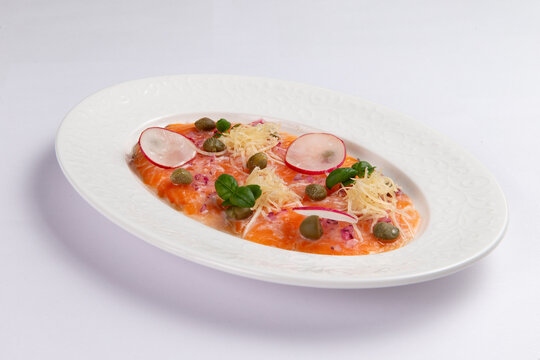 Salmon carpaccio with radish capers and parmesan fine dining