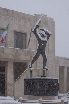 View of the monument to the fallen in front of the town hall during a heavy snowfall in Corridonia, Marche, Italy.