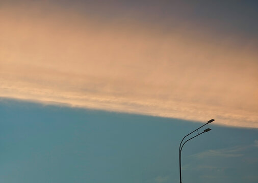 Diagonal smooth clouds over the city lamp post background