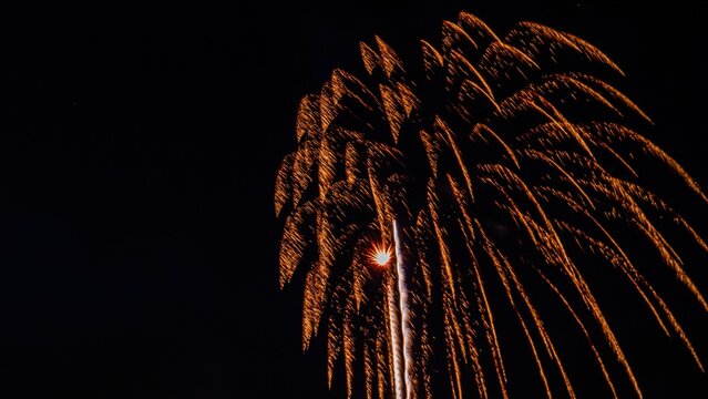 View of golden fireworks exploding in the night sky over Paradise, Pennsylvania, United States.