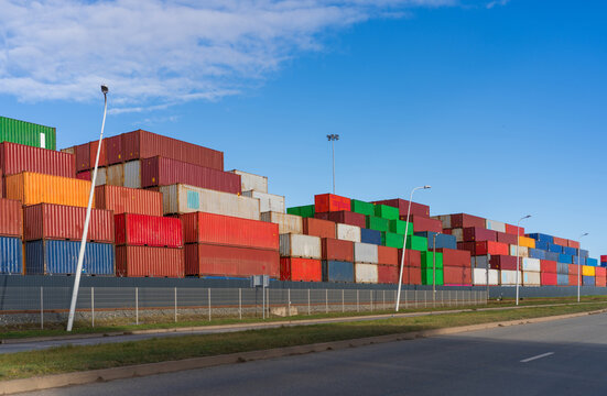 View of stacked colorful shipping containers at the port terminal under a clear blue sky in Klaipeda, Klaipeda County, Lithuania.