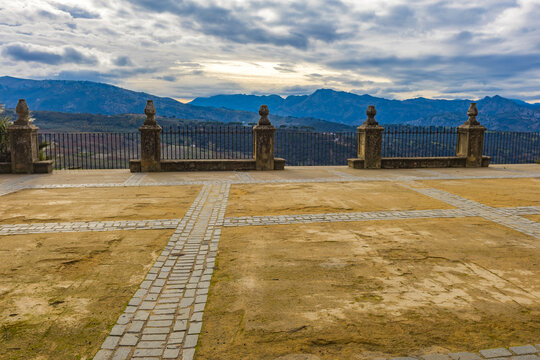 Scenic mountain landscape from historic viewpoint in Ronda Spain under dramatic cloudy sky