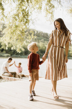 Joyful moments by the water with family during a sunny afternoon