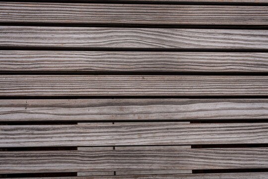 horizontal weathered wooden planks or slats with natural grain patterns. abstract background banner