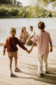 Family moments by the serene lake, capturing love and joy together