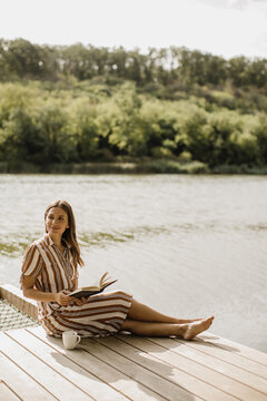 Enjoying a peaceful moment by the serene waters with a good book