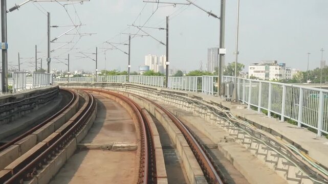Point of View from a Moving Metro Train on Elevated City Tracks