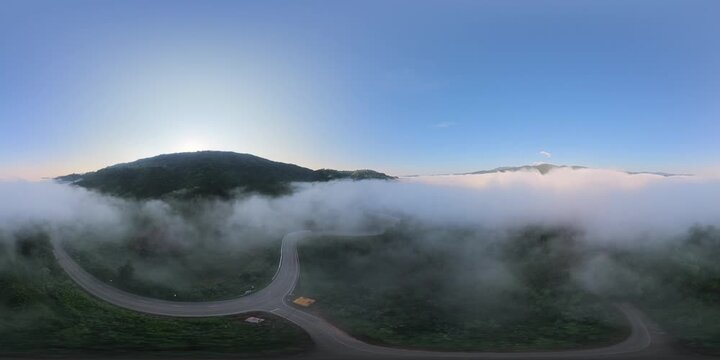 4K 360&deg; Panoramic View of a Winding Mountain Road Through Morning Mist at Phu Kao Ngom, Loei, Thailand