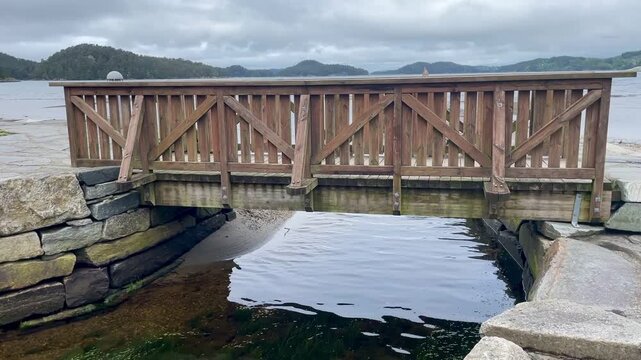 A cute small wooden bridge over a small river