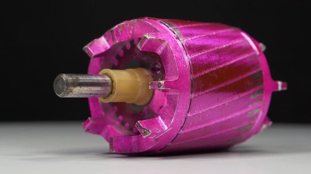 Pink electric motor armature designed for household appliances and used as an essential mechanical component for powering various electrical devices