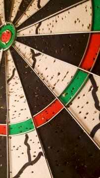 Vertical dartboard for playing darts. Playing darts: throwing darts at the target.