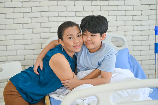 A heartwarming moment between a mother and her young son in a hospital room, showcasing love and care during a challenging time.