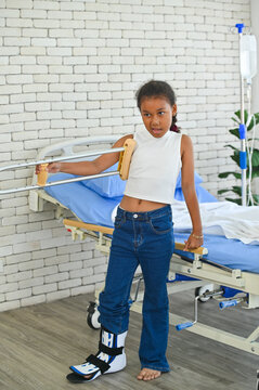 A young girl recovering in a hospital setting, showcasing resilience despite her injuries. She stands with determination, symbolizing hope and strength.