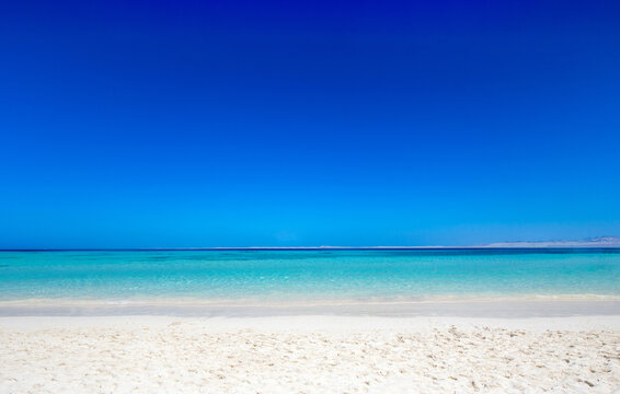 tropical island with white sandy beach and sea
