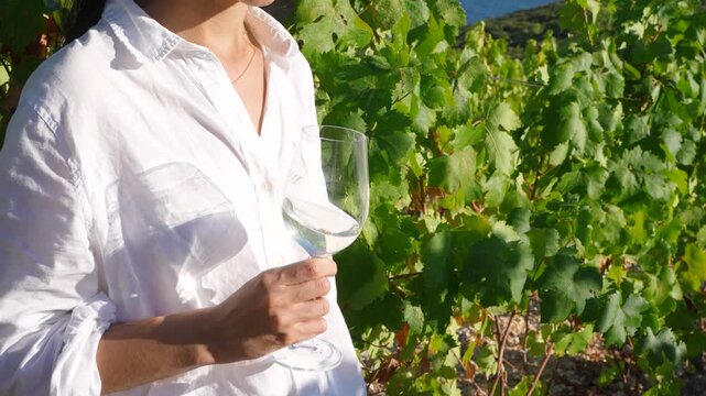 Woman tasting wine in vineyard