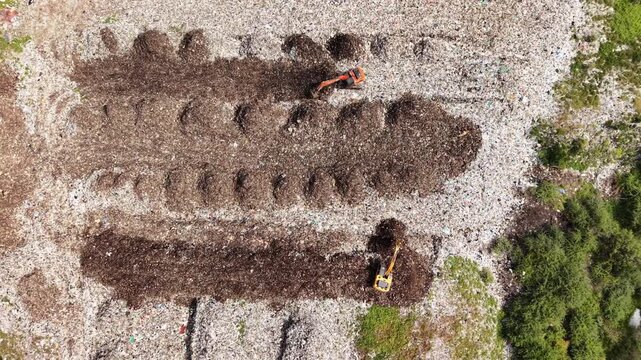 Two cranes segregating wet and dry waste at a recycling unit aerial waste management sustainability