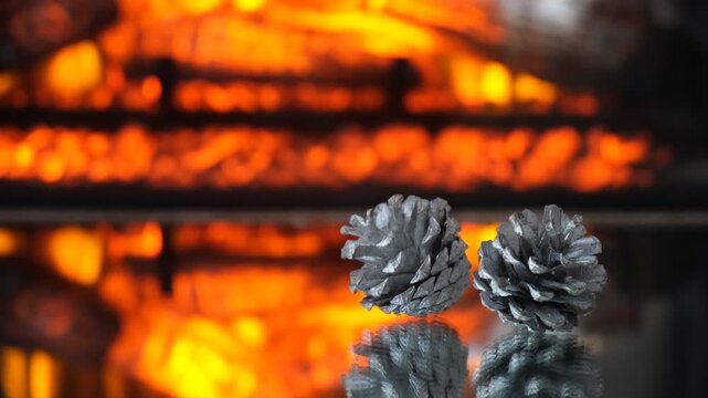 New Year and Christmas background features festive decorations, including elegant silver pine cones that create a soft forest aura. The scene is set near a cozy fireplace, evoking the warmth and comfo