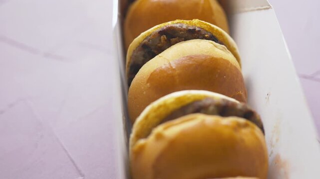 mini burgers or sliders served on a stylish wooden board