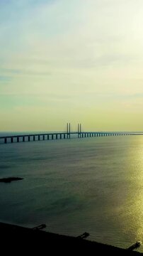 Vertical video. Oresund bridge. A long tunnel and bridge with an artificial island between Sweden and Denmark.. Drone footage. Rich colors