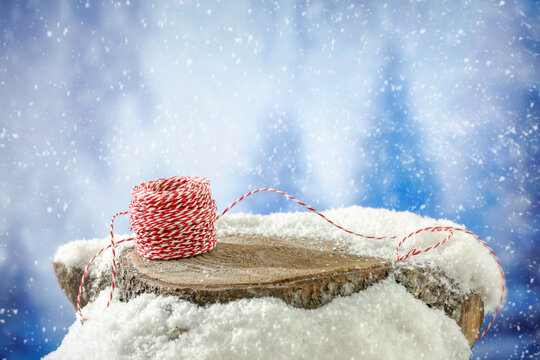 Empty covered with snow tree trunk for product placement, surrounded by fresh snow and a beautiful winter landscape in the background.