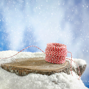 Empty covered with snow tree trunk for product placement, surrounded by fresh snow and a beautiful winter landscape in the background.