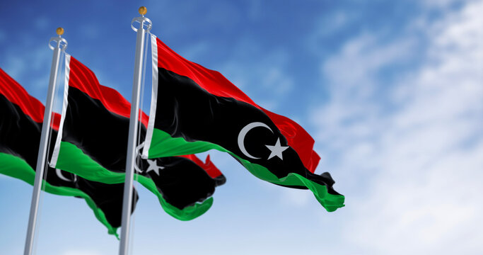 National flags of Libya waving on a clear day.