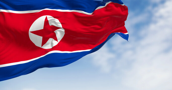Close-up of North Korea national flag waving in the wind on a clear day
