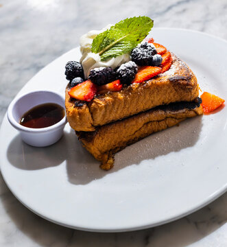 French Toast with Fresh Berries, Whipped Cream and Maple Syrup