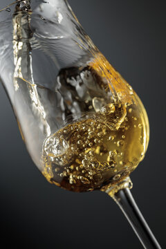 Whiskey is poured is poured into a glass.