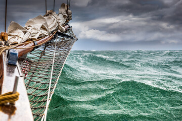 Ship bow plunging through stormy green waves © Georg