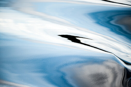 Abstract blue water reflection with dark accent