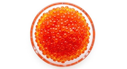Obraz premium Closeup of vibrant red and orange caviar in a clear glass bowl on a white background food