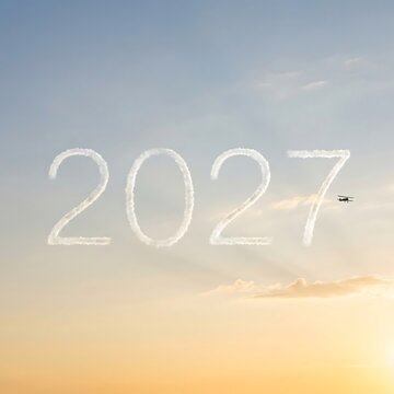 Skywriting of the year 2027 in the sunset sky