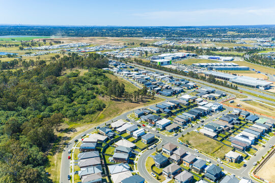 Aerial photograph of houses and buildings and residential development and infrastructure in the fast growing and developing Greater Western Sydney suburb of Oran Park in New South Wales, Australia