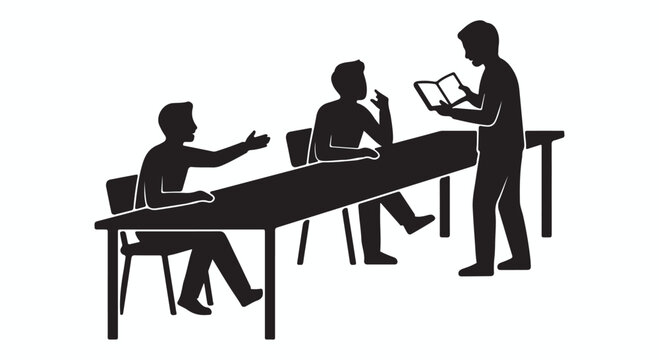 Group of students sitting at a long table and studying with a teacher standing