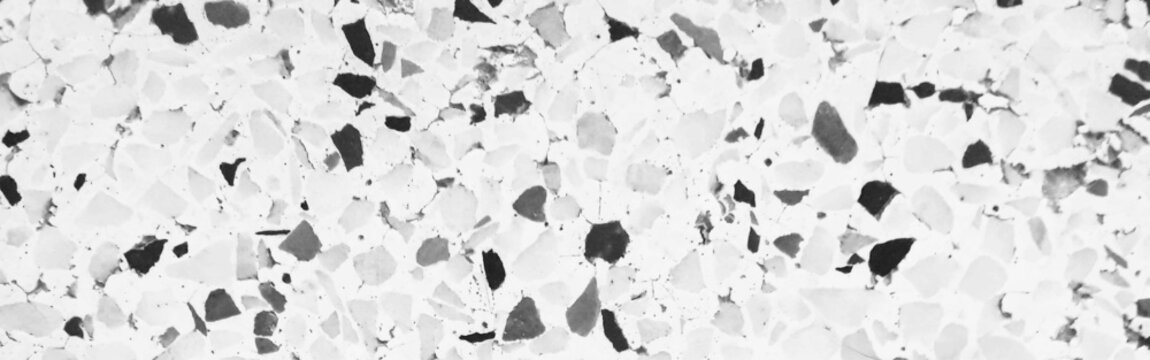 White Terrazzo Texture Background with Black and Gray Stone Chips, Minimalist Monochrome Cement Surface for Flooring and Interior Design.