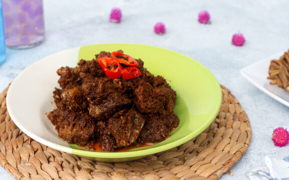 Rendang is a traditional Indonesian dish made from beef chunks slowly braised in rich coconut milk and an aromatic blend of spices. The meat is cooked for hours until the liquid evaporates, resulting 