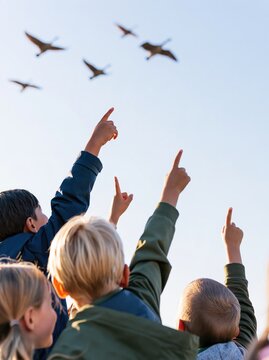 Group of Curious Children Pointing at Migratory Birds in the Sky