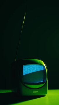Retro TV, vintage television In a nostalgic setup, a retro TV displays grain on screen, scary halloween night device good for chroma key and green screen.