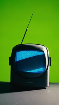 Retro TV, vintage television In a nostalgic setup, a retro TV displays grain on screen, scary halloween night device good for chroma key and green screen.