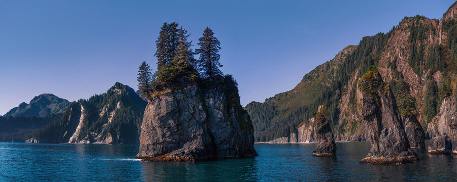 Spire Cove in Seward, Alaska seascape with rocky islands and fir trees in Kenai Fjords National Park, USA